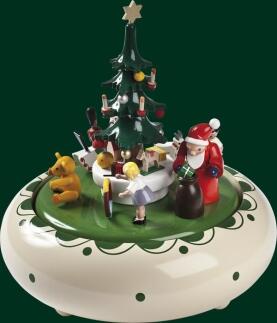 Spieluhr – detailreiche Bescherung mit Weihnachtsmann und bunten Figuren, weißer Unterbau – spielt
